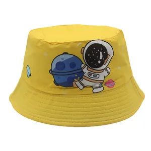 Yellow kids bucket hat featuring a cute cartoon astronaut and planet print for sun protection