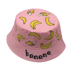 Pink kids bucket hat with yellow banana patterns and banana text on the brim