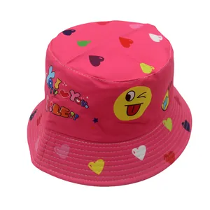 Close-up of pink sun hat featuring colorful hearts and a winking emoji face print