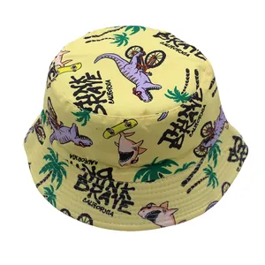 Detail of yellow kids bucket hat with dinosaur prints and Brave California text