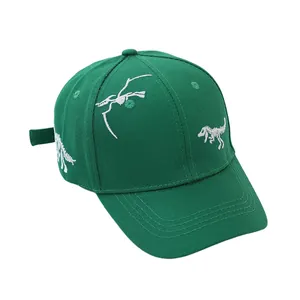 Detailed embroidery of dinosaur skeletons on forest green cotton baseball cap for kids