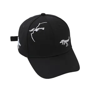 Close-up of dinosaur skeleton embroidery on black cotton baseball cap for kids