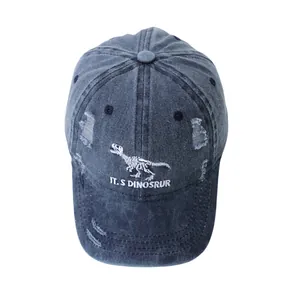 Detail of dinosaur embroidery and distressed wash on a kids' denim baseball cap