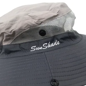 Detail of grey sun shade hat featuring breathable mesh fabric and white embroidery