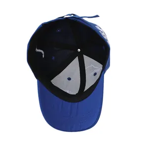 Detail view of the inner structure and reinforced seams of a navy blue dinosaur baseball cap