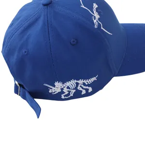 Detail of adjustable metal buckle and triceratops skeleton embroidery on dark blue cap