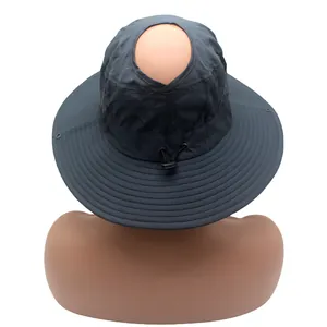 Détail d'un chapeau de soleil à large bord avec trou pour queue-de-cheval et cordon réglable