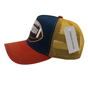 Dettaglio del ricamo football americano su cappellino trucker in rete bicolore