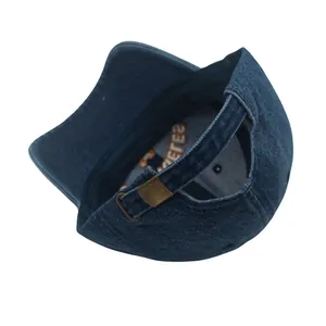 Detail of blue washed denim baseball cap with vintage metal buckle and embroidery