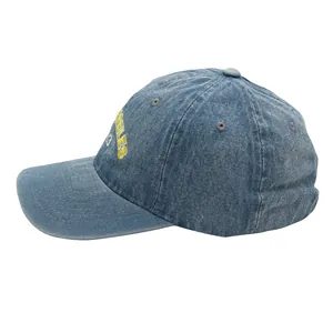 Detailed side view of washed blue denim baseball cap with yellow Los Angeles embroidery