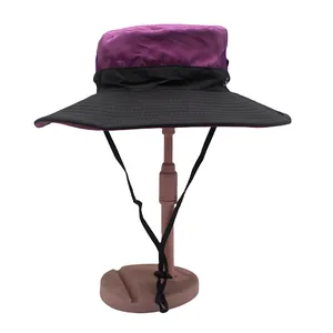 Detail of purple ponytail bucket hat showing breathable mesh vents and adjustable chin strap