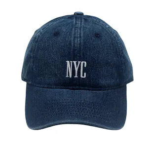 Detailaufnahme der weißen NYC-Stickerei auf einer gewaschenen dunkelblauen Denim-Kappe