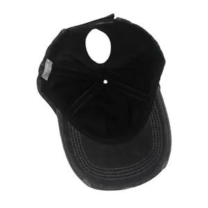 Detail of ponytail hole and washed cotton fabric on distressed gray baseball cap