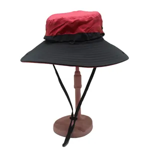 Detail view of red and black sun hat with adjustable chin strap for hiking and fishing