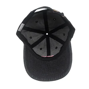 Detail view of cotton denim baseball cap interior showing washing label and metal buckle
