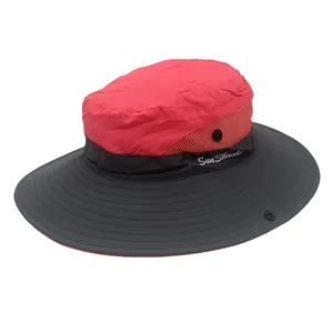 Detail of outdoor sun hat featuring red mesh breathability and dark grey brim design
