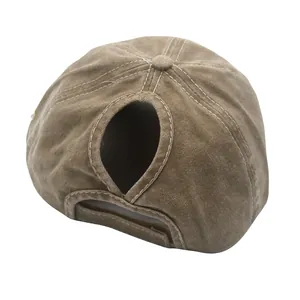 Detail view of the ponytail hole and adjustable velcro strap on the washed khaki baseball cap