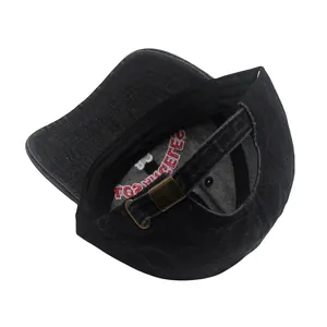 Detail of washed cotton baseball cap featuring adjustable metal buckle and interior embroidery