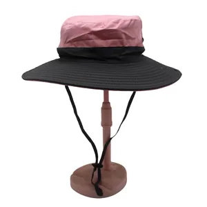 Detail view of the pink and black color-block sun hat with textured ripstop fabric and chin strap
