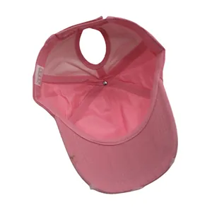 Detailed internal view of pink ponytail baseball cap showing the large rear opening hole