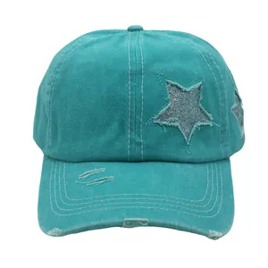 Detail of washed cotton ponytail cap with distressed holes and silver sequin stars