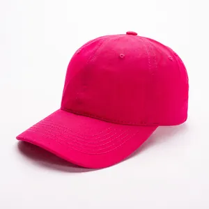 Macro side view of a magenta cotton baseball cap with reinforced curved brim and stitching