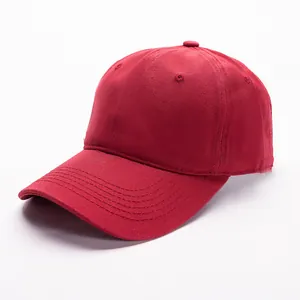Detail view of deep red cotton baseball cap with six-panel structure and reinforced brim