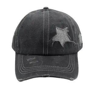 Close-up of charcoal grey washed cotton baseball cap with star patch and distressed details