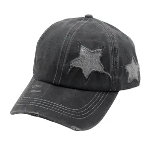 Macro detail of washed denim fabric and distressed star patch on baseball cap