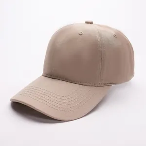 Detailed close-up of khaki cotton twill texture and stitching on the six-panel baseball cap