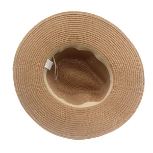 Internal detail of brown straw sun hat showing 100% paper material and sweatband