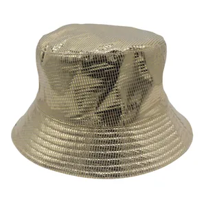 Detail of golden bucket hat featuring metallic grid texture and shiny laser finish