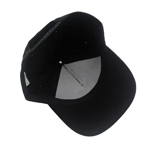 Detail view of black snapback hat interior with adjustable strap and care label