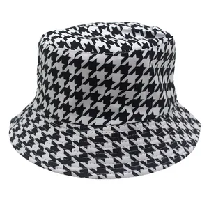 Close-up of high-quality classic black and white houndstooth pattern on a durable cotton bucket hat