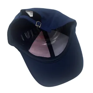 Detailed inner view of navy baseball cap featuring metal buckle and cotton wash label