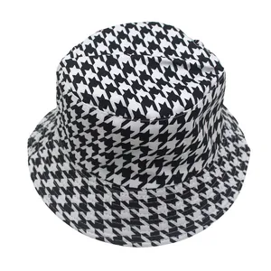 Detailed view of the classic black and white houndstooth pattern on a durable bucket hat