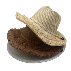 Detail of woven straw sun hats with frayed edges and beaded ties in three colors