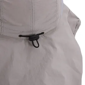 Detail view of the adjustable elastic drawstring and buckle on breathable fishing hat