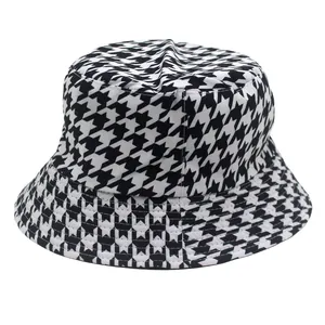 Detail of classic black and white houndstooth pattern texture on cotton bucket hat