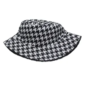 Close-up of classic black and white houndstooth pattern fabric on wide brim bucket hat