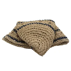Close-up of foldable straw sun hat with navy stripes and textured crochet weaving pattern