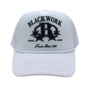 Detailed view of white trucker hat featuring black letter B print and breathable mesh design