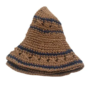 Close-up of foldable straw sun hat with navy stripes and breathable hollow weave pattern