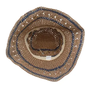 Interior detail of foldable woven straw hat showing sweatband and 100% paper material label