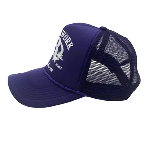 Detail of purple mesh trucker hat featuring white printed B letter and star graphics