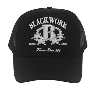 Close-up of black trucker hat with white embroidery and breathable mesh back