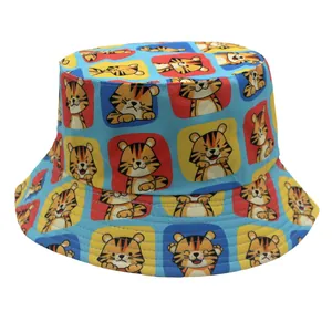 Detail of light blue bucket hat featuring colorful cartoon tiger patterns on canvas fabric