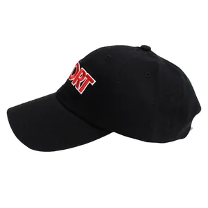 Detailed close-up of the red and white SPORT embroidery on the black cotton baseball cap
