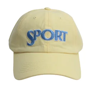 Pale yellow cotton baseball cap featuring blue SPORT embroidery on a classic curved brim