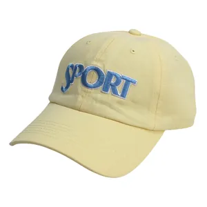 Close-up of light yellow baseball cap with blue SPORT embroidery and premium stitching